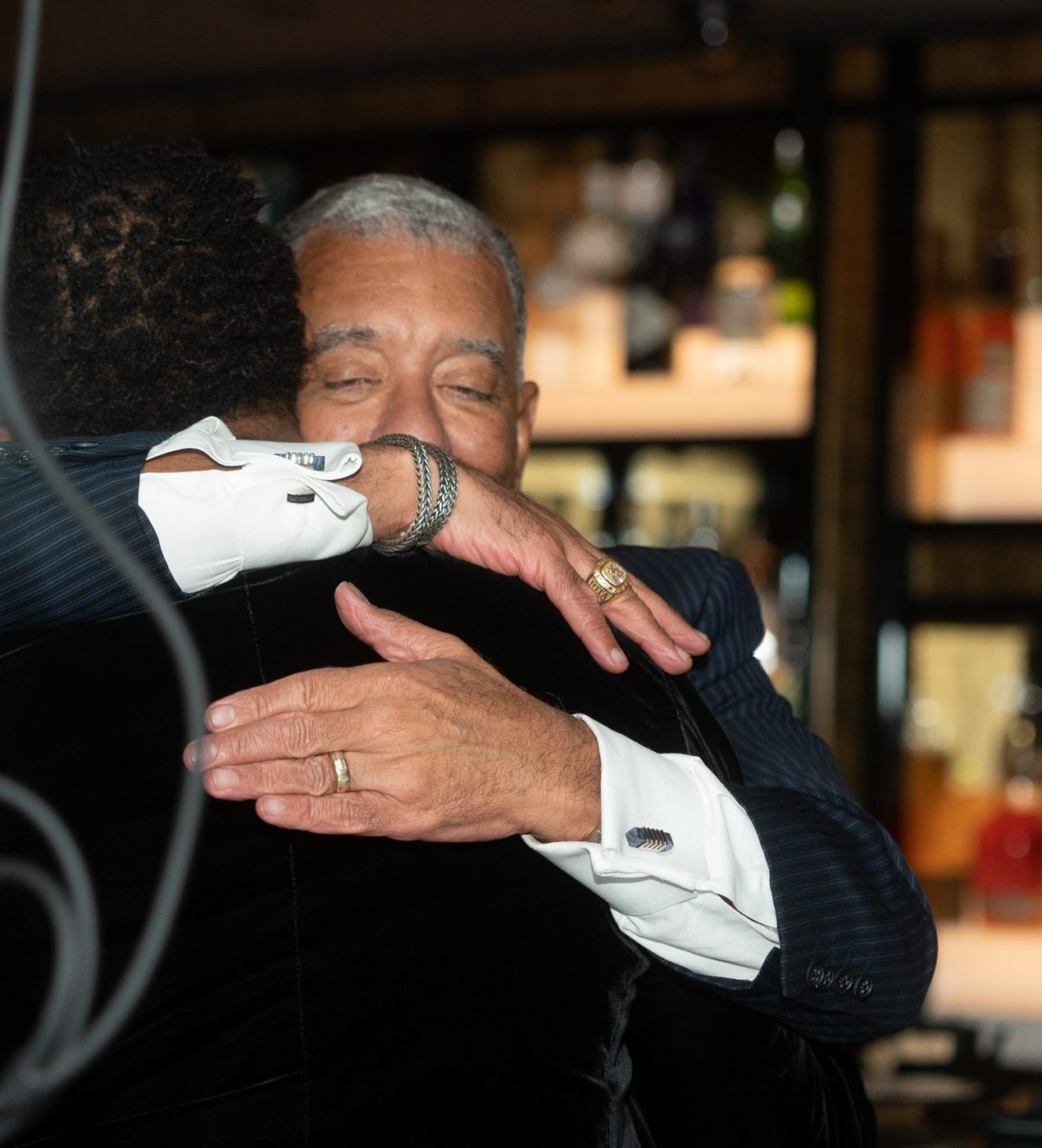 Brian McKinney embraced by Conrad Mallett, then Detroit's Deputy Mayor, at Gayanga's fifth-anniversary celebration