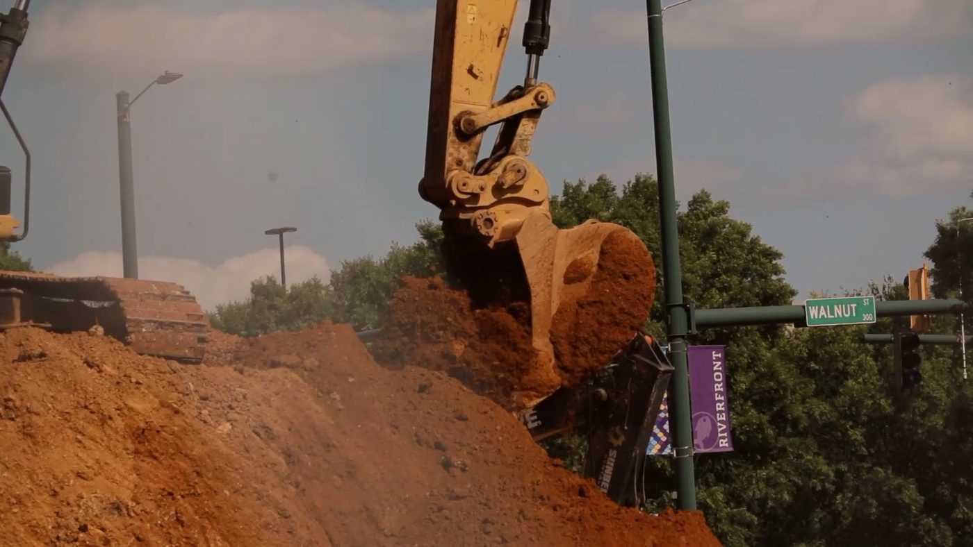 Excavator loading soil at a Detroit site