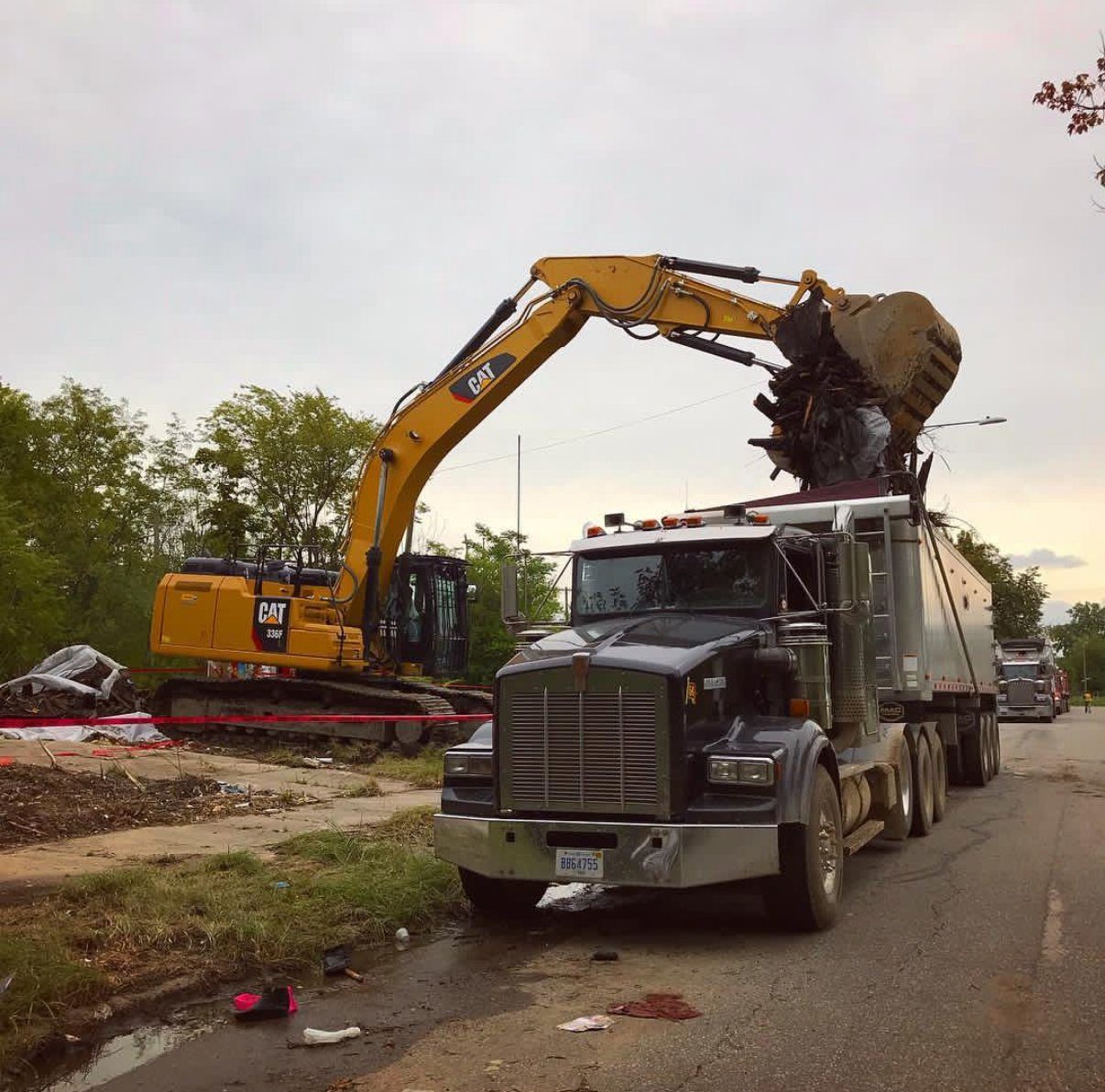 A Gayanga CAT 336 excavator loading a company Kenworth on a Detroit demolition site