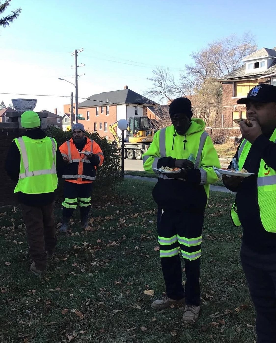 Gayanga crew members eating the company's pre-Thanksgiving meal on a job site, November 2022