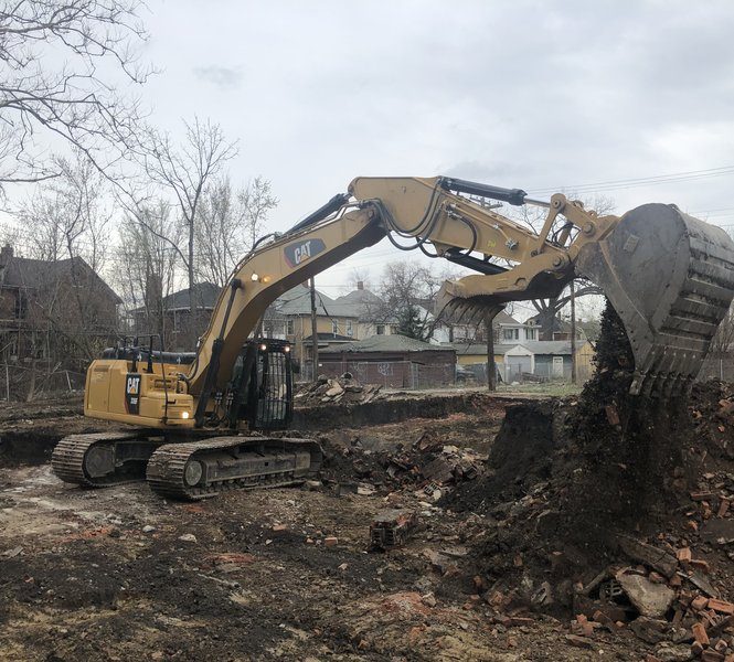 Gayanga CAT excavator taking down a house on a Detroit residential street
