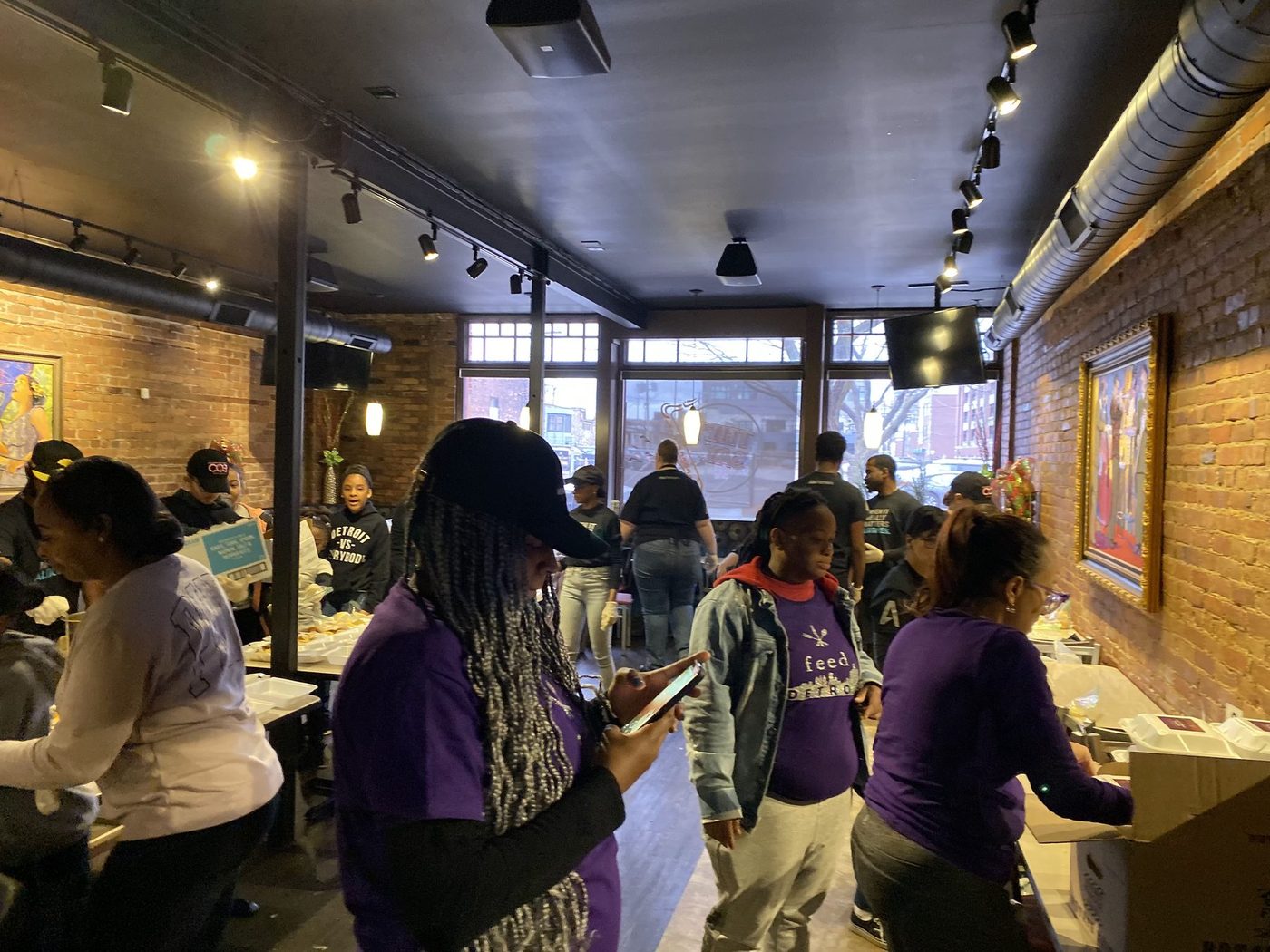 Volunteers in FEED Detroit shirts packing Thanksgiving meals