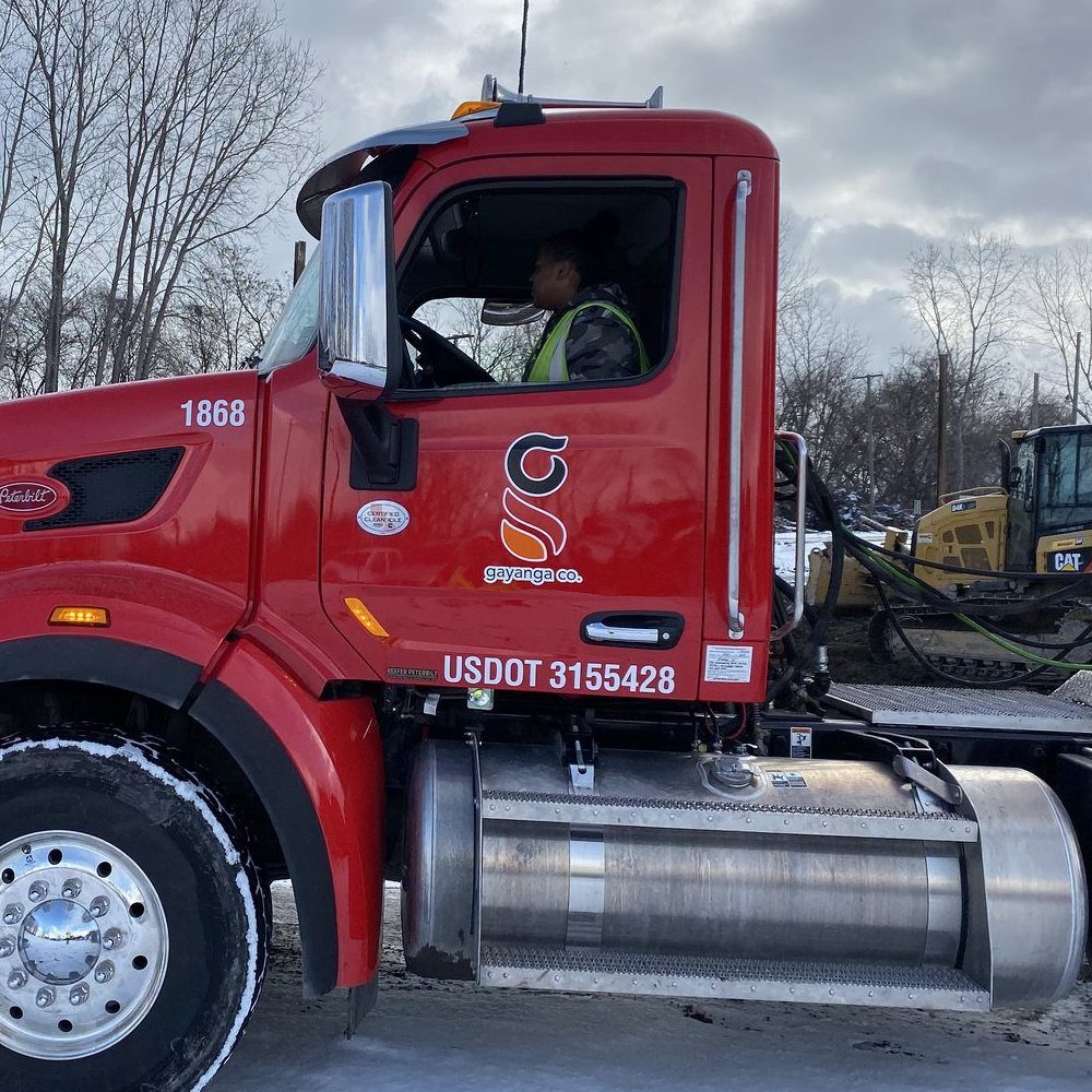 Whitney at the wheel of a Gayanga Co. Peterbilt tractor in the equipment yard