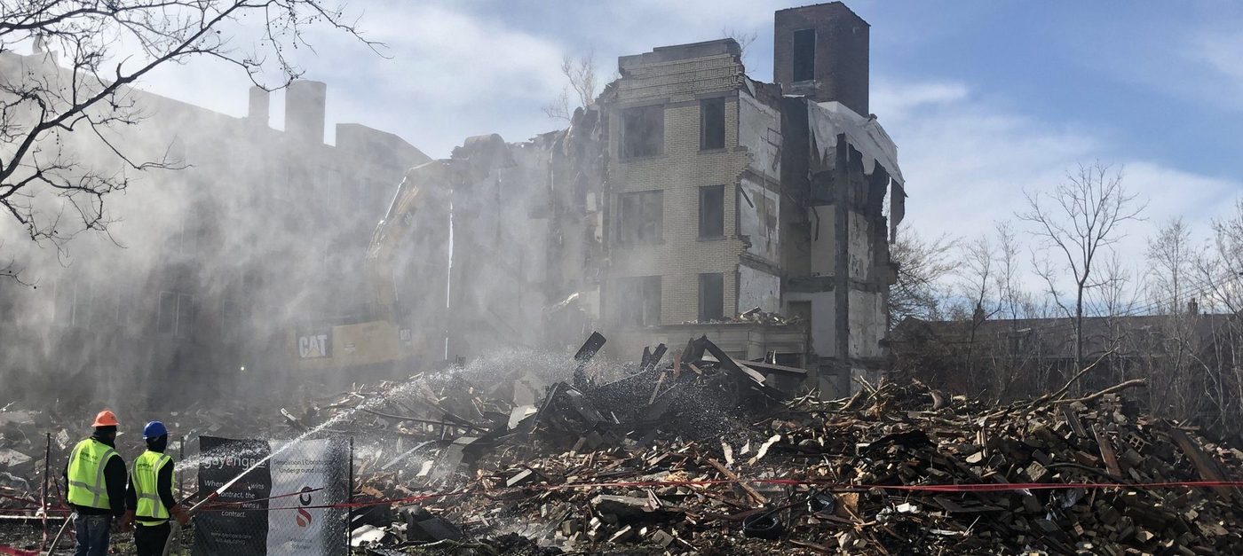 Gayanga crew watching the Historic Woodland apartment building come down under dust suppression, April 2019
